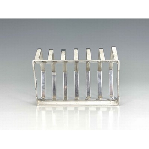 104 - Keith Murray for Mappin and Webb, an Art Deco silver plated six division toast rack, circa 1934, the... 