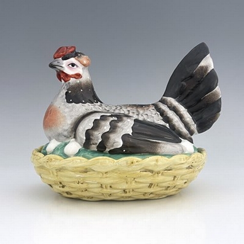 1040 - A Staffordshire pottery hen on nest, circa 1850, yellow basket dish base with cover modelled as a si... 