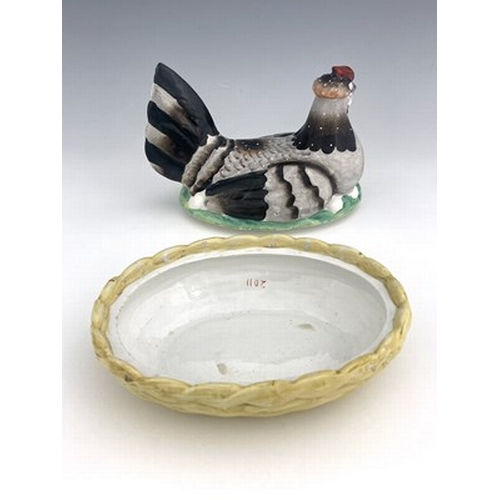 1040 - A Staffordshire pottery hen on nest, circa 1850, yellow basket dish base with cover modelled as a si... 