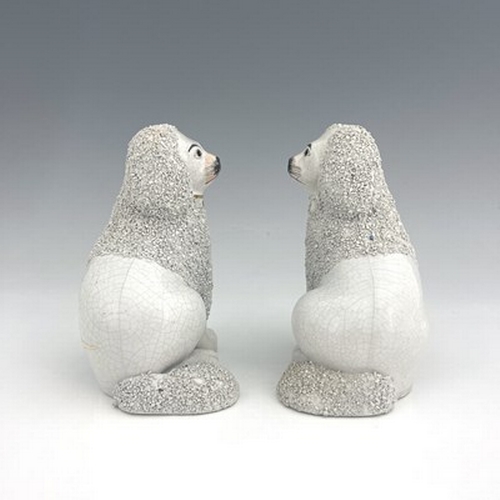 1045 - A Staffordshire matching pair of poodles, circa 1860, seated figures modelled as part-shaved poodles... 