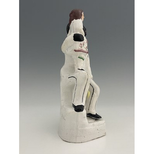 1047 - A Staffordshire figure of 'Uncle Tom' and 'Younge Eva', circa 1850, white enamel with painted polych... 