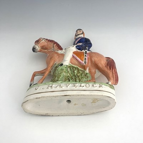 1049 - A Staffordshire portrait figure of Sir Henry Havelock on horseback, painted in polychrome enamels wi... 