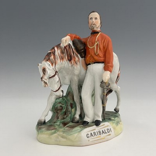 1053 - A Staffordshire figure of Garibaldi, by Thomas Parr, circa 1865, modelled standing beside his horse,... 