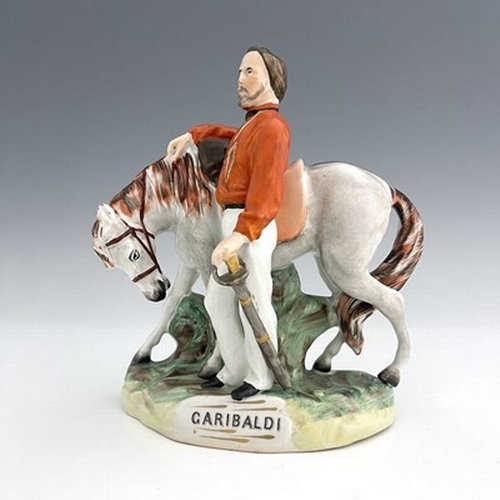 1053 - A Staffordshire figure of Garibaldi, by Thomas Parr, circa 1865, modelled standing beside his horse,... 