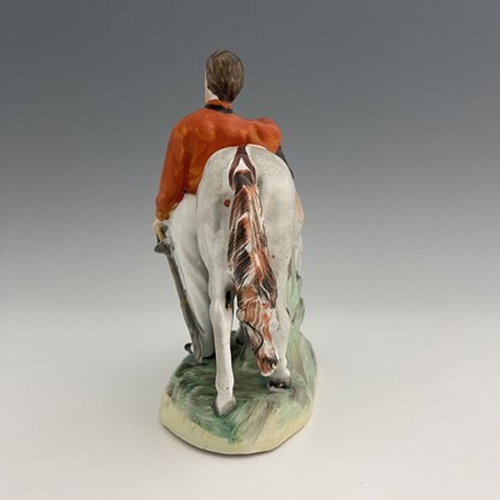 1053 - A Staffordshire figure of Garibaldi, by Thomas Parr, circa 1865, modelled standing beside his horse,... 