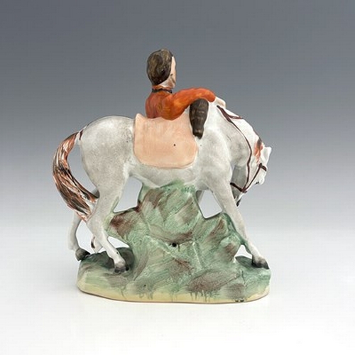 1053 - A Staffordshire figure of Garibaldi, by Thomas Parr, circa 1865, modelled standing beside his horse,... 