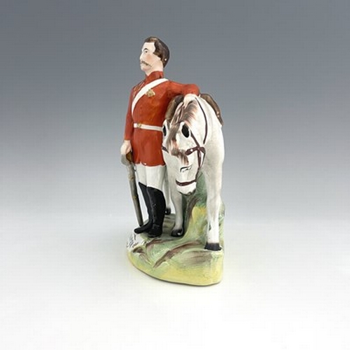 1053 - A Staffordshire figure of Garibaldi, by Thomas Parr, circa 1865, modelled standing beside his horse,... 