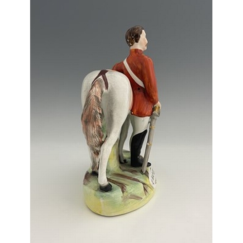 1053 - A Staffordshire figure of Garibaldi, by Thomas Parr, circa 1865, modelled standing beside his horse,... 