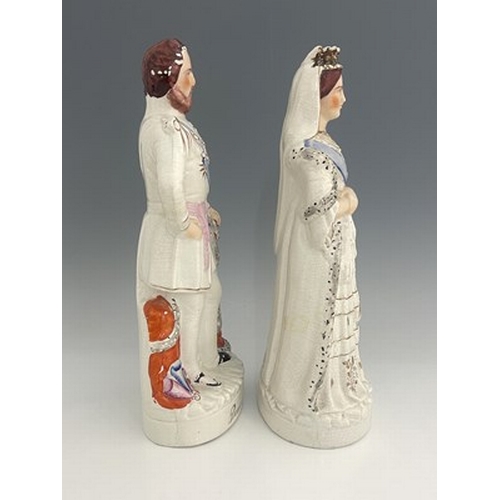 1055 - A pair of large Staffordshire portrait figures of 'The Queen' and 'The Prince of Wales', circa 1870,... 