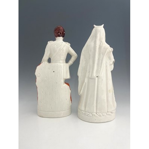 1055 - A pair of large Staffordshire portrait figures of 'The Queen' and 'The Prince of Wales', circa 1870,... 