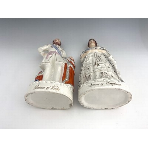 1055 - A pair of large Staffordshire portrait figures of 'The Queen' and 'The Prince of Wales', circa 1870,... 