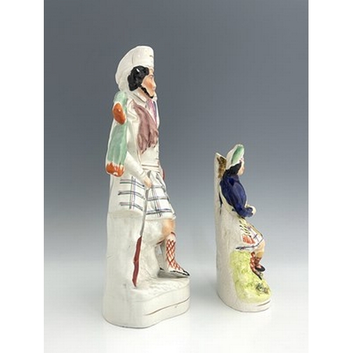 1058 - A Staffordshire spill vase, circa 1860, modelled as a seated mustachioed figure in Highland dress, s... 