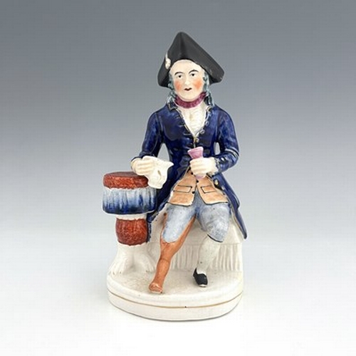 1060 - A Staffordshire figure of a Greenwich Hospital pensioner, circa 1850, modelled as a seated sailor wi... 