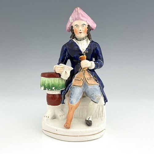 1061 - A Staffordshire figure of a Greenwich Hospital pensioner, circa 1850, modelled as a seated sailor wi... 