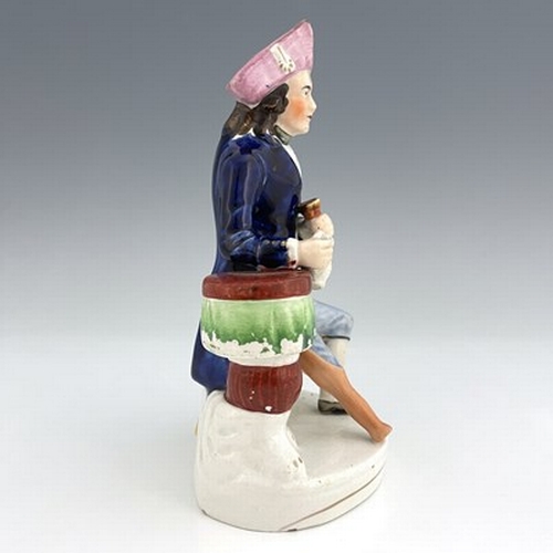 1061 - A Staffordshire figure of a Greenwich Hospital pensioner, circa 1850, modelled as a seated sailor wi... 