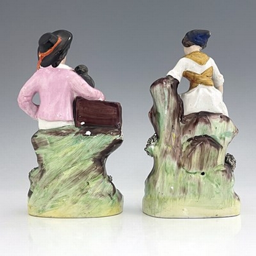 1063 - A Staffordshire figure pair of street performers, circa 1860, painted in polychrome enamel with gild... 