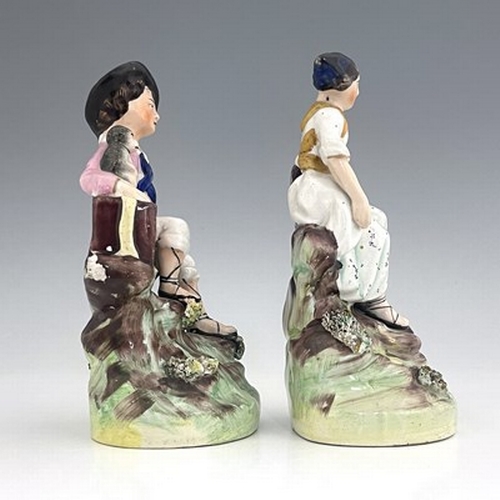 1063 - A Staffordshire figure pair of street performers, circa 1860, painted in polychrome enamel with gild... 