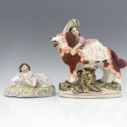 1065 - A Staffordshire figure group of children with dogs, circa 1860, larger figure modelled as a girl in ... 