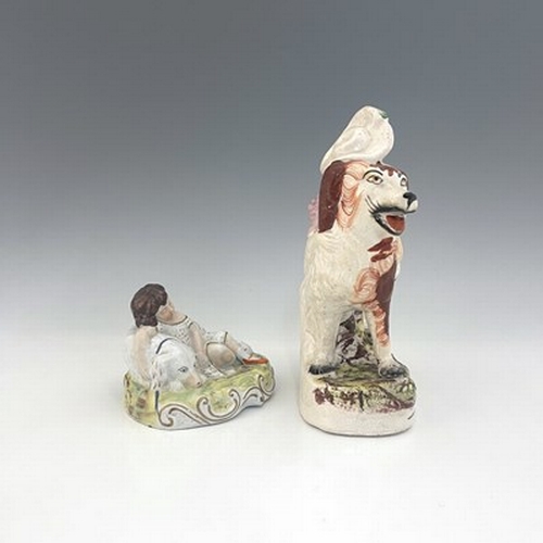 1065 - A Staffordshire figure group of children with dogs, circa 1860, larger figure modelled as a girl in ... 