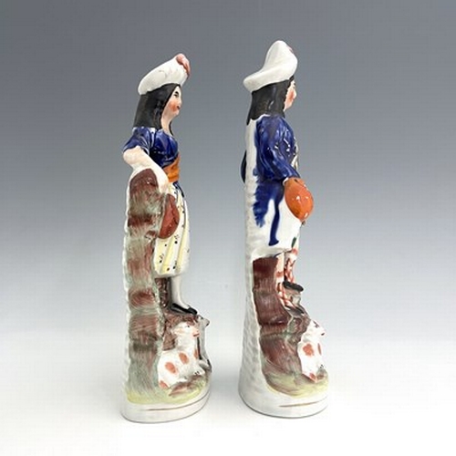 1066 - A pair of Staffordshire shepherd and shepherdess figures in Scottish Highland dress, circa 1850, Sco... 