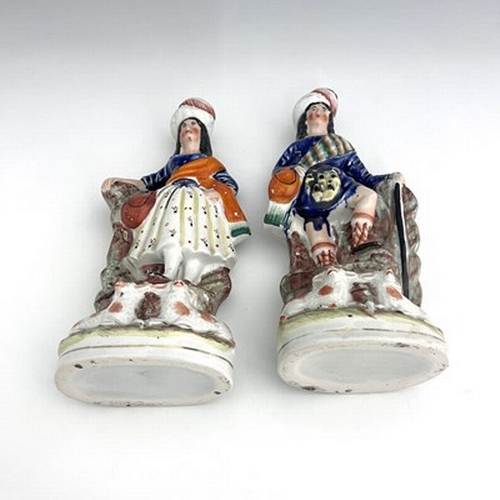 1066 - A pair of Staffordshire shepherd and shepherdess figures in Scottish Highland dress, circa 1850, Sco... 