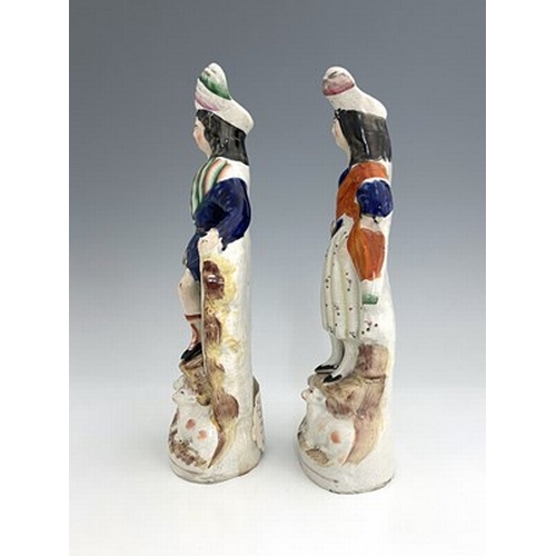 1067 - A pair of Staffordshire shepherd and shepherdess figures in Scottish Highland dress, circa 1850, Sco... 