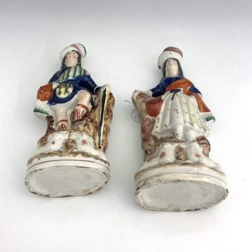 1067 - A pair of Staffordshire shepherd and shepherdess figures in Scottish Highland dress, circa 1850, Sco... 