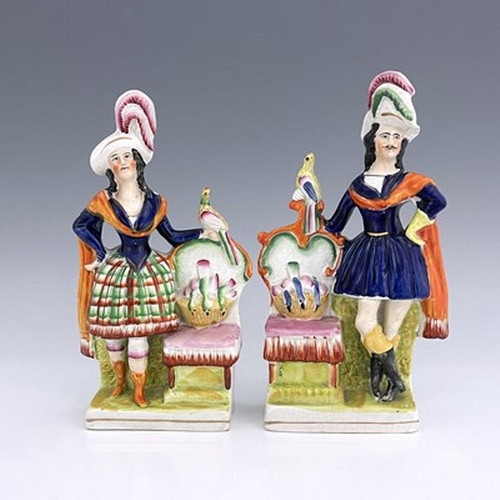 1069 - A pair of Staffordshire pottery figures, circa 1860, modelled as ornately dressed male and female fi... 