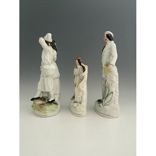 1071 - Three Staffordshire figure groups , circa 1865, one modelled as a standing male fruitseller in white... 