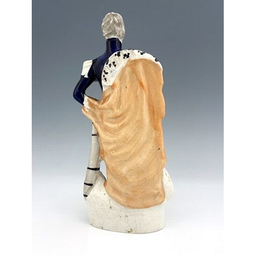 1075 - A Staffordshire portrait figure of Wellington, circa 1840, modelled standing in his blue dress unifo... 