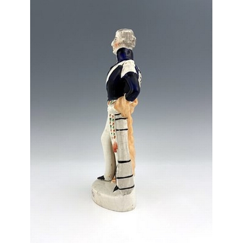 1075 - A Staffordshire portrait figure of Wellington, circa 1840, modelled standing in his blue dress unifo... 