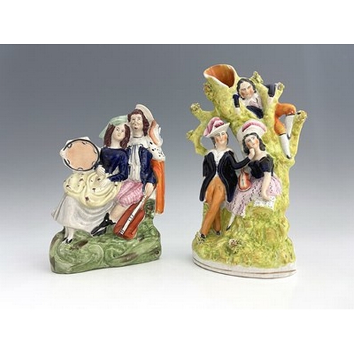 1079 - A Staffordshire figure group of musicians/lovers, circa 1850, arboreal scene modelled as a pair of l... 