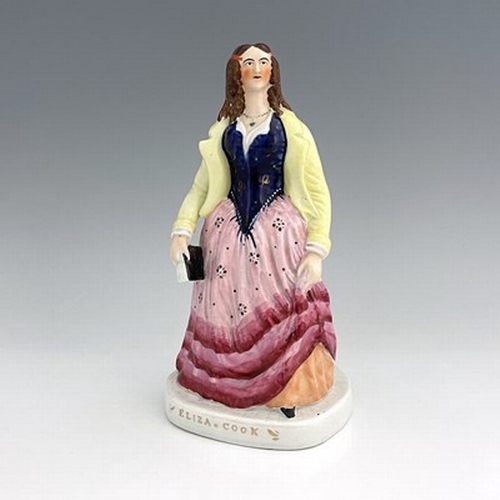 1081 - A Staffordshire figure of 'Eliza Cook', circa 1850, modelled standing female figure holding a book o... 