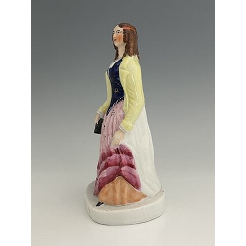 1081 - A Staffordshire figure of 'Eliza Cook', circa 1850, modelled standing female figure holding a book o... 