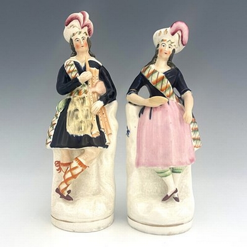 1084 - Staffordshire figure pair of Scottish musicians and dancers, circa 1850, modelled as a standing male... 