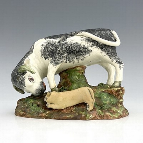 1091 - A Staffordshire pearlware pottery bull baiting figure group, circa 1820, sponge decoration with dog,... 