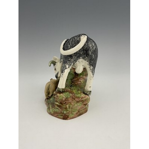 1091 - A Staffordshire pearlware pottery bull baiting figure group, circa 1820, sponge decoration with dog,... 