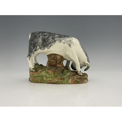 1091 - A Staffordshire pearlware pottery bull baiting figure group, circa 1820, sponge decoration with dog,... 