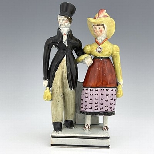 1092 - A Staffordshire pearlware figure group of the Dandies, early 19th century, on square platform base, ... 