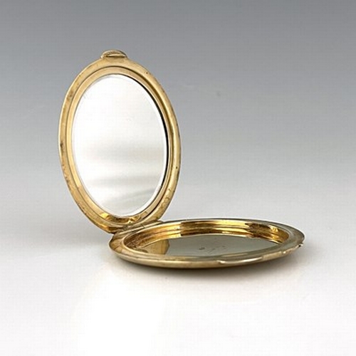 110 - An Art Deco 9 carat gold compact, Goldsmiths and Silversmiths Company, London 1937, circular, engine... 