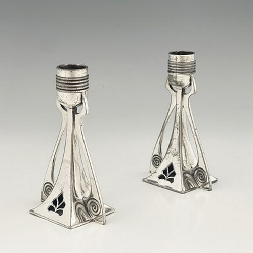 125 - WMF, a pair of Jugendstil silver plated candlesticks, buttressed square section trumpet form, pierce... 