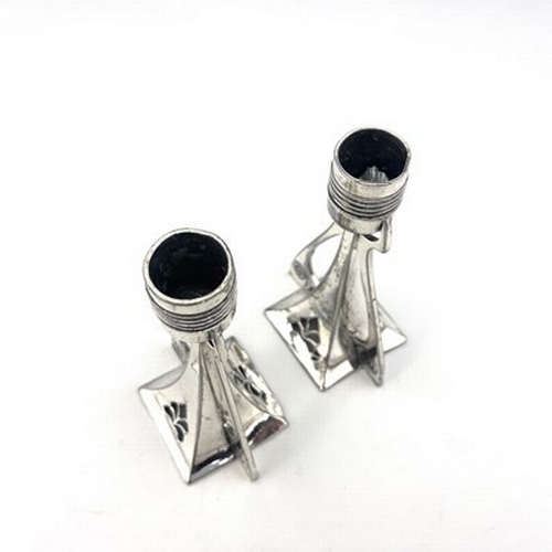 125 - WMF, a pair of Jugendstil silver plated candlesticks, buttressed square section trumpet form, pierce... 