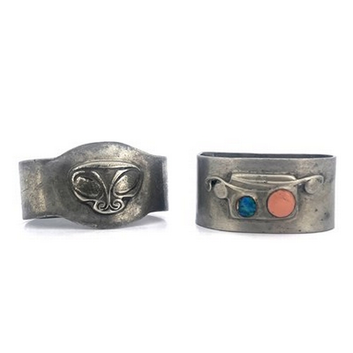 139 - Archibald Knox for Liberty and Co., two Tudric Arts and Crafts pewter napkin rings, one with enamell... 