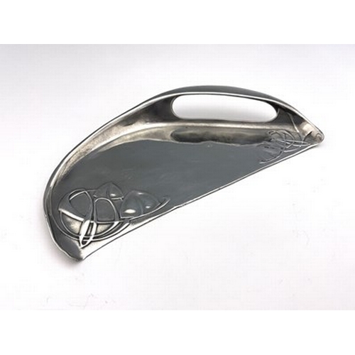 140 - Archibald Knox for Liberty & Co, a Tudric pewter crumb scoop, circa 1905, half-moon form with integr... 