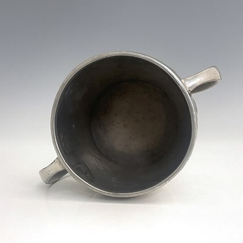 141 - Archibald Knox for Liberty and Co., an Arts and Crafts Tudric pewter twin handled mug, model 0929, o... 