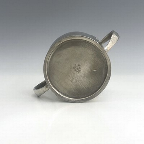 141 - Archibald Knox for Liberty and Co., an Arts and Crafts Tudric pewter twin handled mug, model 0929, o... 