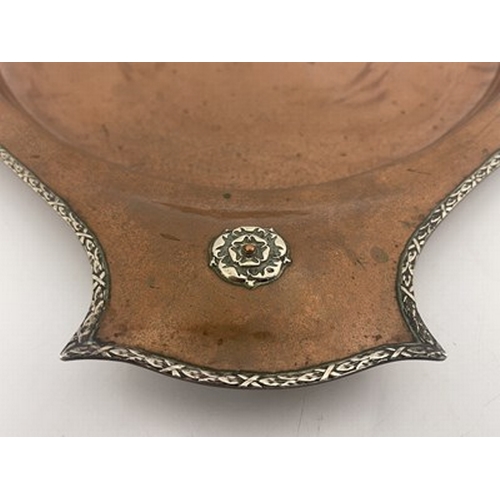 147 - A E Jones, an Arts and Crafts copper and silver tray, circa 1920, planished twin handled oval form w... 