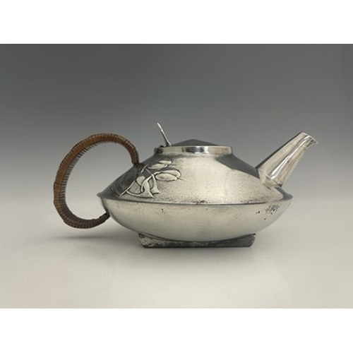 153 - Archibald Knox for Liberty and Co., a Tudric pewter teapot, 0231, squat form with rattan handle and ... 