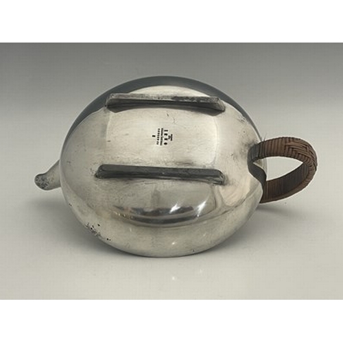 153 - Archibald Knox for Liberty and Co., a Tudric pewter teapot, 0231, squat form with rattan handle and ... 