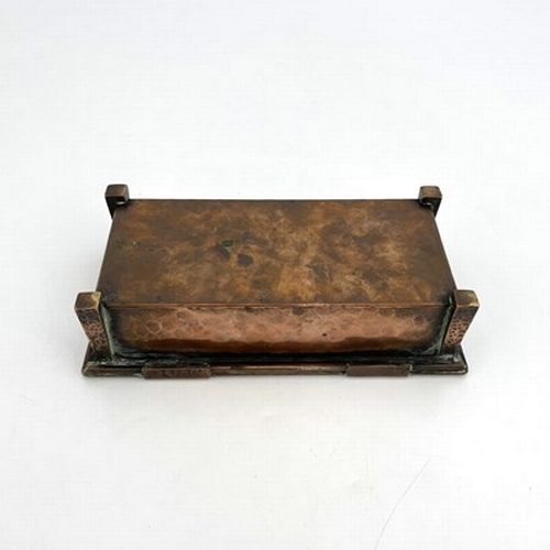 155 - An Arts and Crafts copper lidded ink casket, planished cuboid form with tapered obelisk legs, the si... 